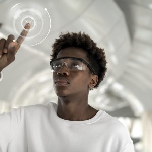 Man wearing smart glasses touching a holographic screen Man wearing smart glasses touching a holographic screen
